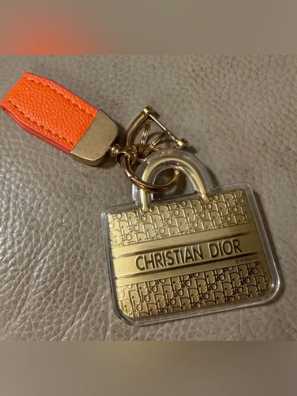 Designer inspired Gold colored Logo Bag Charm Keychain with Orange Strap